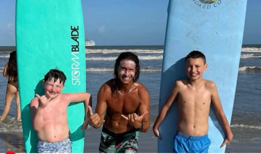 Certified instructor coaching beginners during a group surf lesson in Cocoa Beach