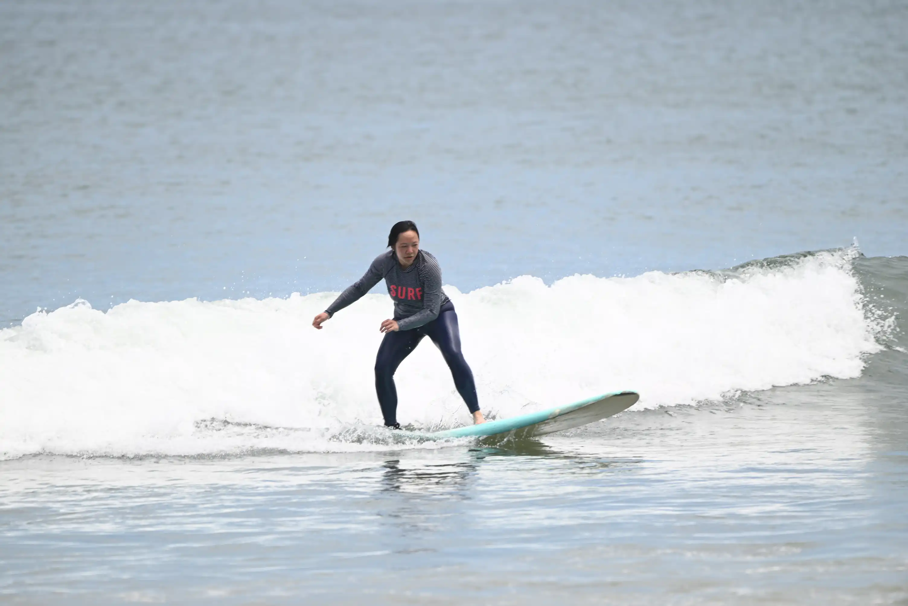 Kids surf camp at Cocoa Beach Florida — small group session with certified instructor in the ocean